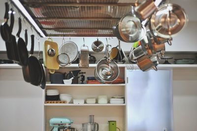 Low angle view of utensils hanging in kitchen