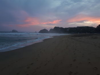 Scenic view of beach against sky during sunset