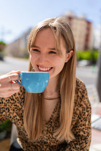 Portrait of young woman drinking glass