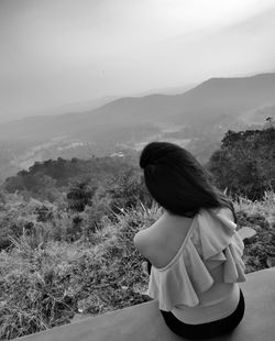 Rear view of woman looking at mountains
