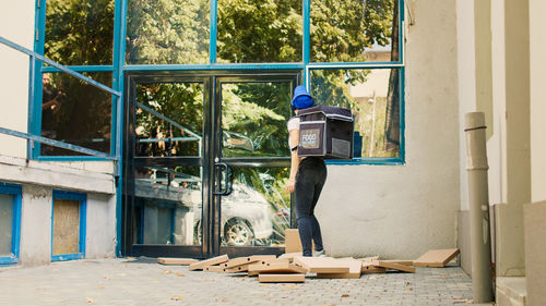 Rear view of man standing against wall