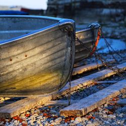 Close-up of nautical vessel on shore during winter