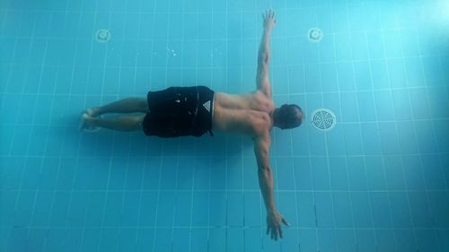 Man swimming in pool