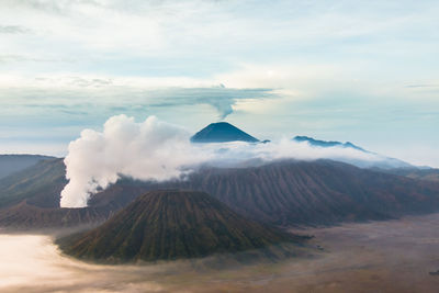 View of volcanic landscape against cloudy sky