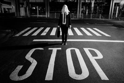 Woman standing on road