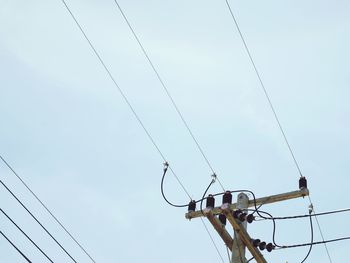 Low angle view of electricity pylon against sky