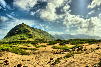 Scenic view of mountains against cloudy sky