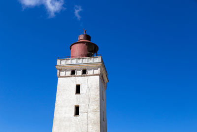 Low angle view of lighthouse against blue sky