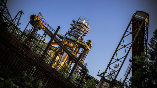 Low angle view of amusement park against sky