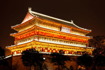 Illuminated building against sky at night