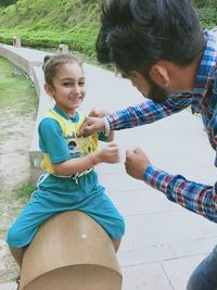 Full length of a smiling girl holding camera