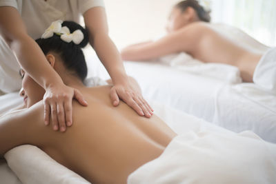 Young woman being massaged on table in spa