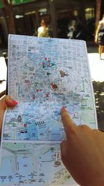 Cropped image of hand holding paper