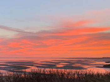 Scenic view of sea against romantic sky at sunset