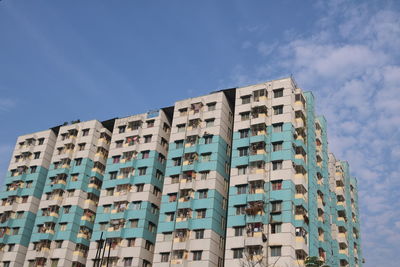 Low angle view of buildings against blue sky
