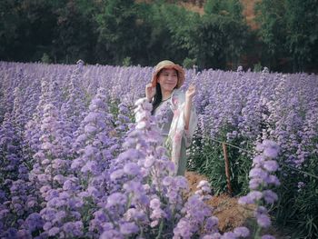 High angle view of woman with pink flowering plants