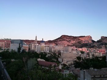 Buildings in city against clear sky