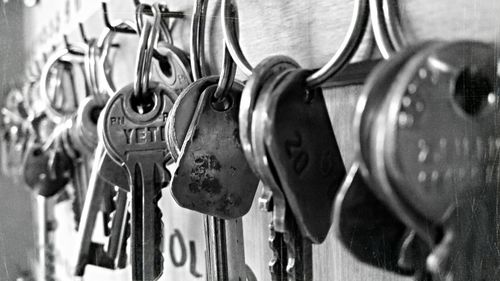 Close-up of keys handing on door