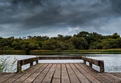 Pier over lake against sky