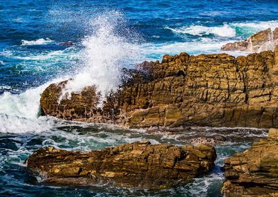 Scenic view of sea waves splashing on rocks