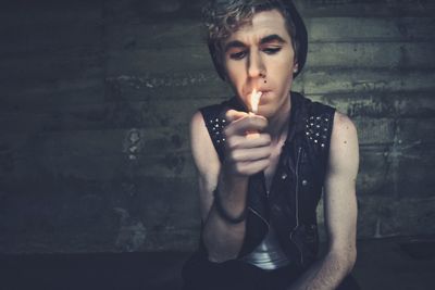 Close-up of young man smoking outdoors