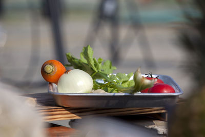 Close-up of vegetables in tray on cutting board