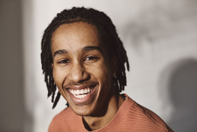 Portrait of happy man against white background in studio