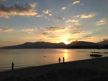 People on a beach at sunset