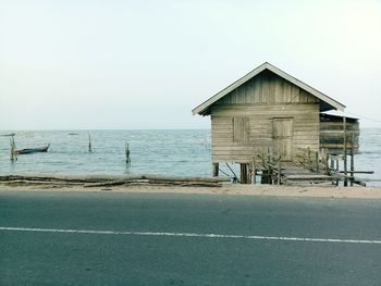 House by sea against clear sky