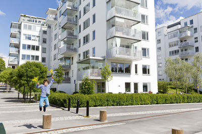 Boy jumping over concrete pole