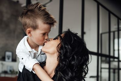 Happy boy kissing mother