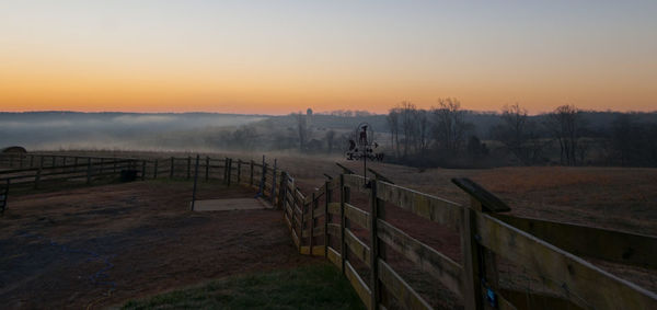 Scenic view of field against sky during sunset