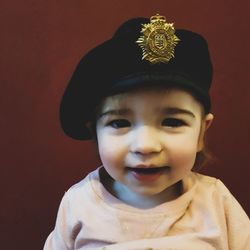 Portrait of cute boy against gray background