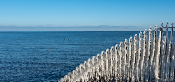 Ice-covered stair railing on the baltic sea coast in winter