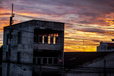 Low angle view of building against sky at sunset