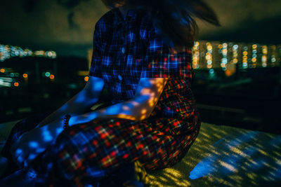 Woman in illuminated room
