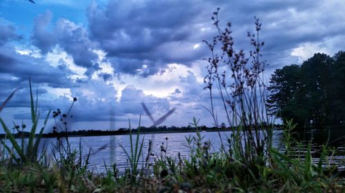 Scenic view of lake against cloudy sky