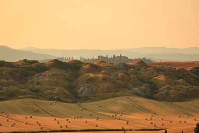 Scenic view of field against sky during sunset