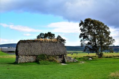 Built structure on field against sky