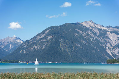 Scenic view of lake and mountains against sky