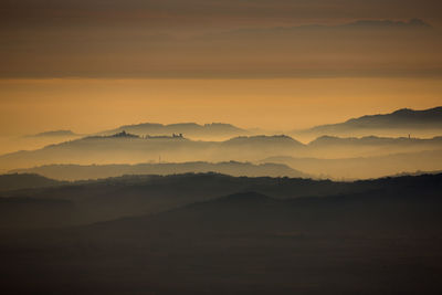 Scenic view of silhouette mountains against sky during sunset