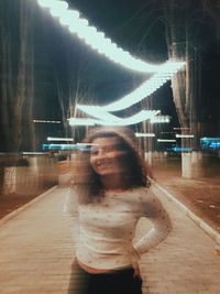 Digital composite image of woman standing at night