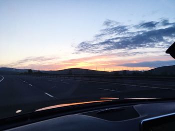 Close-up of road against sky during sunset