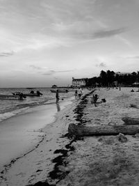 People on beach against sky