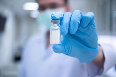 Close-up of hand holding bottle