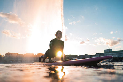 Man and woman against bright sun during sunset