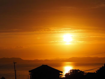 Scenic view of sea against romantic sky at sunset