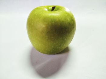 High angle view of apple on table against white background
