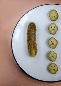 Close-up of pickled cucumber in plate on table