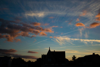 Low angle view of silhouette buildings against sky at sunset